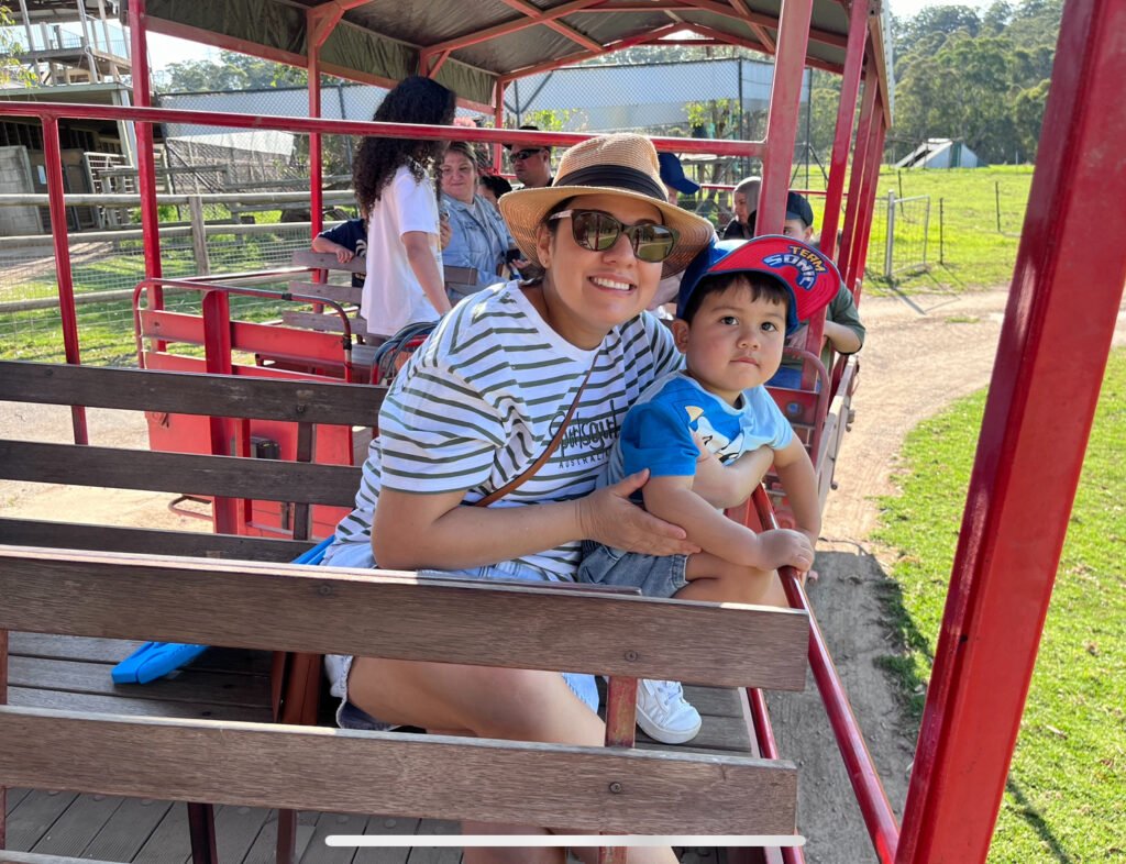 benji and mama sitting on the backseat of the animal tractor ride